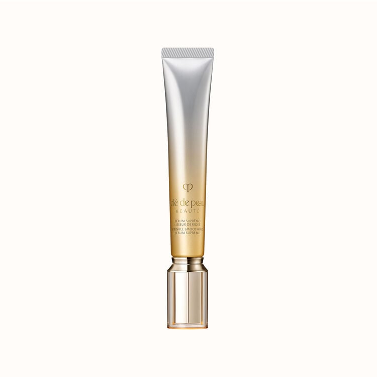 A gold and silver tube of Clé de Peau Beauté Wrinkle Smoothing Serum Supreme, with a metallic gold cap.
