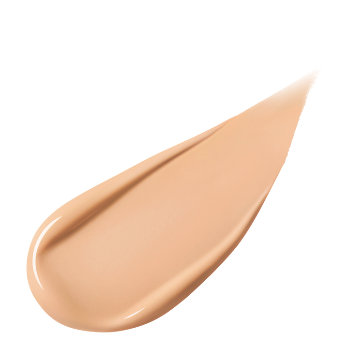 A pear-shaped swipe of light-colored liquid foundation, slightly thicker at one end and tapering to a point, against a white background.