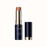 Open stick concealer SPF 27 in a light beige shade with a dark case and matching cap standing beside it.