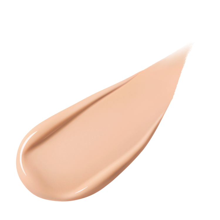 A pear-shaped swipe of light-colored liquid foundation, slightly thicker at one end and tapering to a point, against a white background.