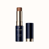 Open stick concealer SPF 27 in a light beige shade with a dark case and matching cap standing beside it.