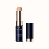Open stick concealer SPF 27 in a light beige shade with a dark case and matching cap standing beside it.