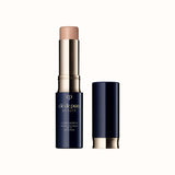 Open stick concealer SPF 27 in a light beige shade with a dark case and matching cap standing beside it.