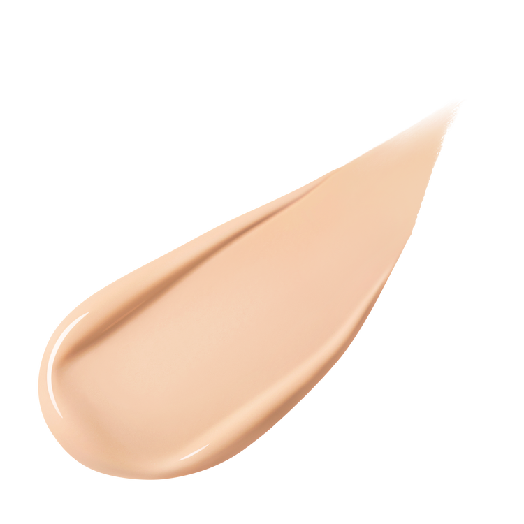 A pear-shaped swipe of light-colored liquid foundation, slightly thicker at one end and tapering to a point, against a white background.