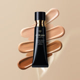 A cosmetic tube of radiant cream foundation SPF 25 lying vertically on top of four horizontal swatches of makeup in shades ranging from light beige to deep brown.
