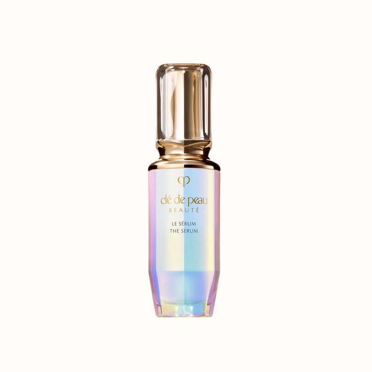 Clé de Peau Beauté "Le Sérum" in a prismatic glass bottle with a gold pump top.