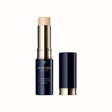 Open stick concealer SPF 27 in a light beige shade with a dark case and matching cap standing beside it.
