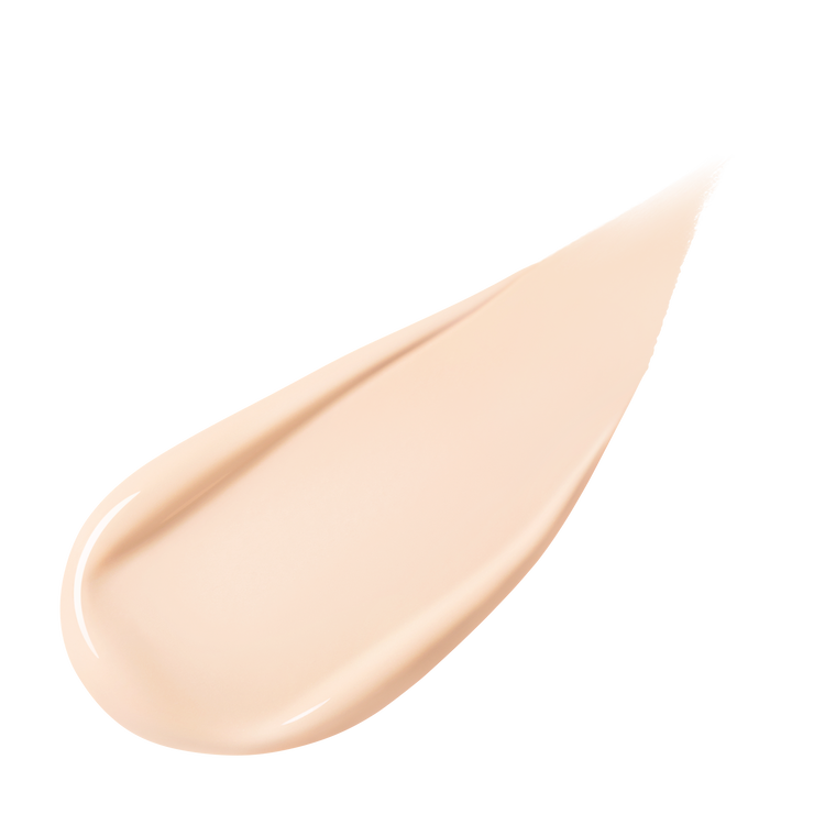 A pear-shaped swipe of light-colored liquid foundation, slightly thicker at one end and tapering to a point, against a white background.