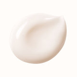 A smooth, creamy, light peach-colored cosmetic product blob on a white background.